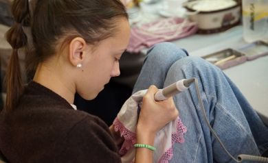 Dziewczyna pracująca nad własną kroszonką za pomocą specjalnego urządzenia