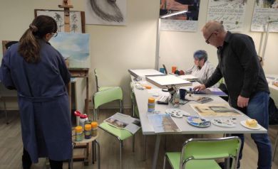 Kobiety i mężczyzna pracujące nad swoimi dziełami. 