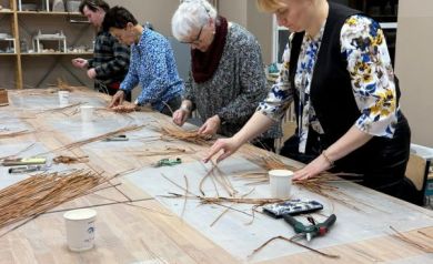 Uczestnicy warsztatów pracujący nad wykonaniem tacek katalońskich. 